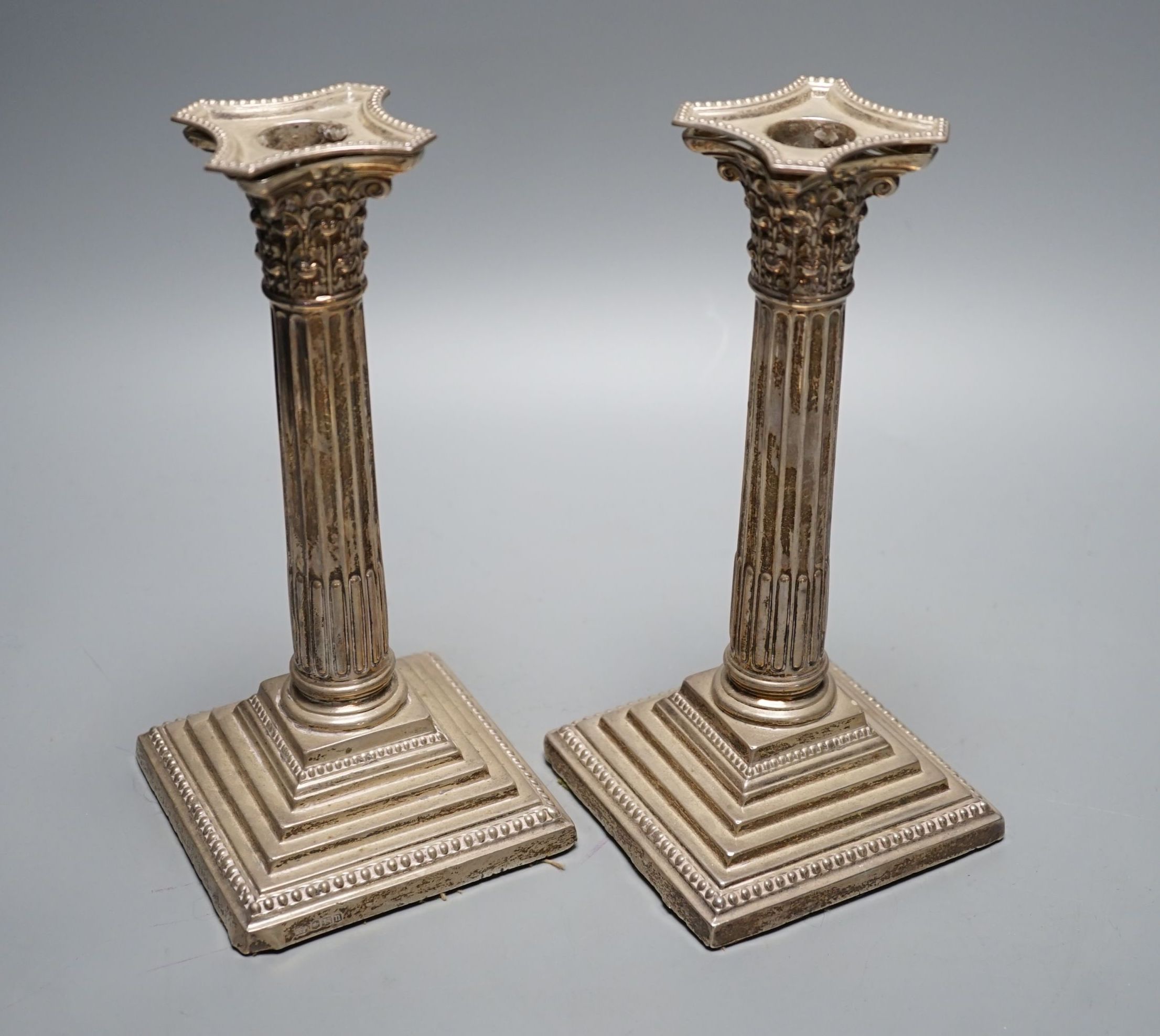 A pair of George V silver Corinthian column candlesticks, Robert Pringle & Sons, Sheffield, 1930, height 21.6cm, weighted.